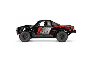 Studio side profile of the ARRMA MOJAVE 6S 1/7 EXB black desert truck featuring red and grey sponsor graphics.