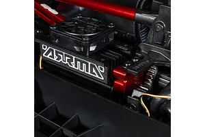 Close-up of the black and red brushless motor with cooling fan inside the ARRMA MOJAVE 6S RC car chassis.