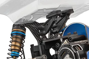 Close-up of the carbon fiber rear shock tower, aluminum shock absorber with blue accents, and body mounts on an RC car.