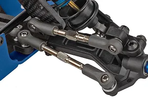 Close-up studio view of the front suspension, turnbuckles, carbon fiber shock tower, and blue aluminum parts on an RC car.