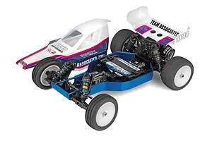 Team Associated RC10 Factory Team Blue Edition RC buggy shown with body shell removed, exposing the blue chassis, electronics, and shock absorbers.