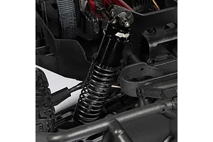 Close-up of the black anodized aluminum shock absorber and coil spring on the ARRMA Mojave 6S RC truck chassis.