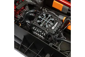 Close-up of the installed Firma electronic speed controller and wiring inside the chassis of an Arrma Mojave 6S RC truck.