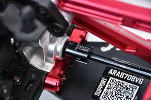 Close-up view of an installed black GPM carbon steel outdrive cup on an RC vehicle drivetrain assembly.