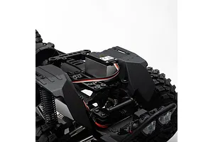 Close-up of the internal chassis and servo of the Axial SCX10 III RC rock crawler against a white background.