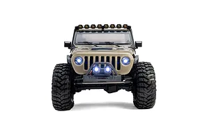 Front view of the Axial SCX10 III Motobilt Valyrian RC rock crawler in tan, showcasing illuminated headlights and bumper lights.