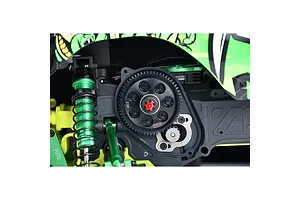 Installed GPM silver motor mount plate and spur gear inside a green and black RC monster truck chassis.
