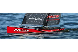 Joysway Focus V3 RC sailboat racing yacht in red and black sailing on open water.