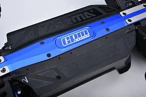 Close-up of a blue anodized GPM Racing aluminium chassis brace and skid plate installed on an RC car chassis.