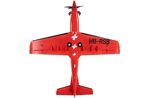 Top-down studio view of the E-Flite Pilatus PC-21 RC plane in red livery with Swiss cross markings and HB-RSB registration on the wing.