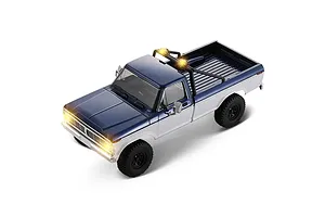 High angle studio shot of the FMS FCX18 II Ford F-100 RC rock crawler in blue and white with active lights.