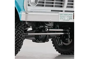 Close-up of the front suspension, axle, and steering linkage on the FMS FCX18 Ford F-100 RC rock crawler.
