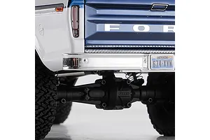 Close-up view of the rear end and suspension of the blue and white FMS FCX18 Ford F-100 RC rock crawler truck model.