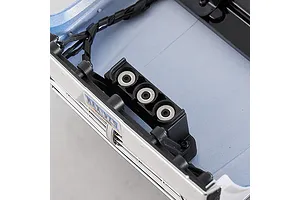 Close-up interior view of the FMS FCX18 II Ford F-100 RC crawler blue body shell showing front mounting detail and wiring.