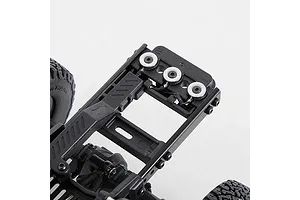Close-up of an RC car chassis frame and mechanical components against a white background