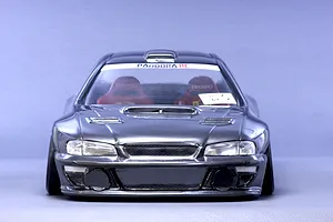 Front view of a dark grey Pandora RC Subaru Impreza 22B STi model body shell featuring interior bucket seats against a plain studio background.