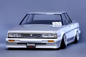 Front three-quarter studio view of a painted Toyota Cresta GX71 RC drift car body shell mounted on a chassis with custom wheels.