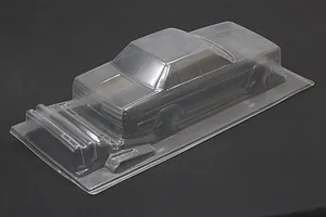 Unpainted clear polycarbonate RC car body shell for a Toyota Cresta GX71 on a black background.