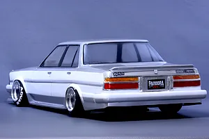 Rear three-quarter view of a Pandora RC Toyota Cresta GX71 RC drift car body shell painted white and silver with deep dish wheels.