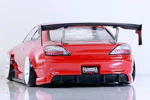 Rear view of a red Pandora RC S13 Silvia radio-controlled drift car model featuring a large black spoiler and white rims against a plain background.