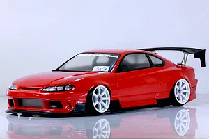 Red RC drift car body styled like an S13 Silvia with white wheels, black aero parts, and a rear wing on a white background.