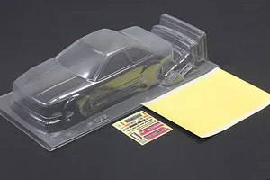 Clear unpainted polycarbonate Pandora RC Toyota Soarer Z20 body shell with included mask sheet and decals on a dark surface.
