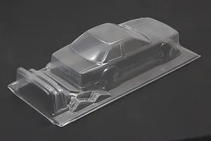 Unpainted clear polycarbonate 1/10 scale RC car body shell on a dark surface