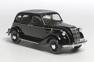 A high-angle studio shot of a black Tamiya 1/24 scale Toyota Toyoda Model AA plastic model car on a white background.