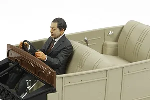A detailed 1/24 scale plastic model of a Toyota Model AA interior with a painted driver figure sitting in the front seat.