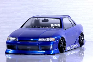 Blue Pandora RC HCR32 2Dr BN Sports body shell mounted on an RC drift car on a white reflective surface.