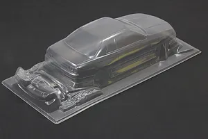 Unpainted clear polycarbonate RC car body shell for a Nissan Skyline R32 2-door with BN Sports styling, shown on a dark background.