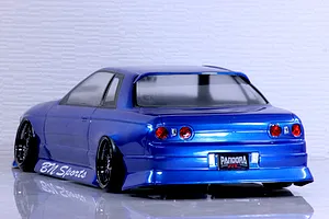Rear-three-quarter view of a blue Pandora RC HCR32 2Dr BN Sports 8400 drift body shell on a reflective surface.