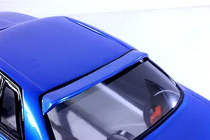 Close-up angled shot of the blue painted roof and rear window visor on a Pandora RC HCR32 2Dr RC drift body shell.