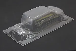 Uncut and unpainted clear polycarbonate RC car body shell for a Toyota Probox on a dark surface.