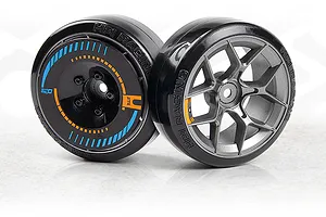 Two 1/10 scale RC drift car wheels and tires with black smooth plastic tyres and detailed rims against a white background.