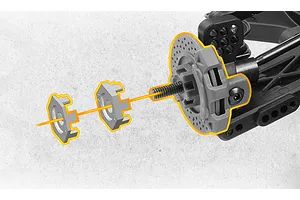 Close-up diagram of an RC car wheel hex and brake disc assembly showing installation parts aligned on an axle against a textured background.