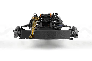 Close-up studio view of an RC drift car front chassis and foam bumper with orange graphic adjustment lines.