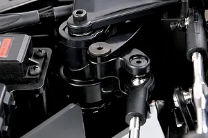 Close-up of black plastic RC car steering assembly, linkage rods, and digital servo from the Rovan Voyager 5 V2.