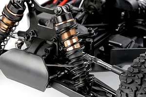 Close-up of the front suspension and shock absorber assembly on the Rovan Voyager 5 V2 1/5 scale RC buggy.