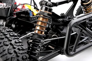 Close-up view of the adjustable metal shock absorber and suspension components on the Rovan ELT320S V2 RC truck.