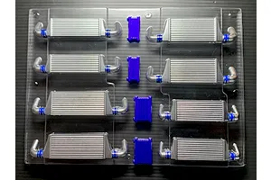Uncut polycarbonate RC body accessory sheet containing multiple intercoolers and oil cooler parts in silver and purple.