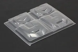 Unpainted clear plastic over fender set sheet for RC body shell on a dark surface.