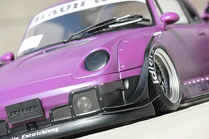 Close-up of a purple RWB wide body RC car showing the front fender set, front wheel, and front bumper details.