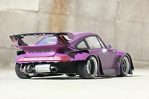 Rear-three-quarter view of a purple Pandora RC Porsche body shell featuring wide fenders, a large rear wing, and custom exhaust details.