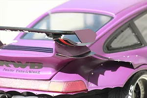 Close-up of the rear section of a purple RC drift car body shell, showing wide fender flares, spoiler wing, and RWB lettering.