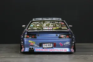 Rear view of a blue Pandora RC HCR32 Skyline body shell featuring custom decals, a rear spoiler, twin exhaust pipes, and BN-Sports branding.
