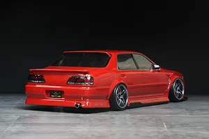 Rear-three-quarter view of a red Pandora RC Toyota Cresta JZX100 drift body shell on a chassis, displayed against a dark studio background.