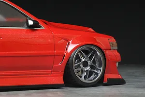 Close-up of the front quarter and wheel of a red RC drift car body with custom wide body styling and silver multi-spoke wheel.