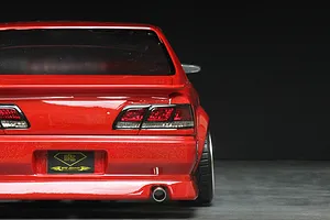 Rear view of a red Pandora RC Toyota Cresta JZX100 drift body shell featuring detailed taillights and an exhaust tip.