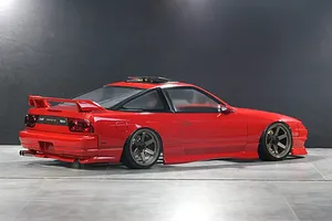 Painted red Pandora RC RPS13 180SX Kouki drift body shell with bronze wheels on a grey surface.